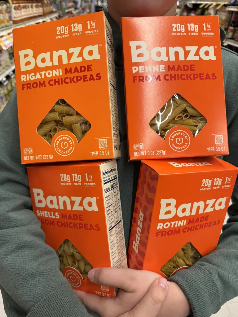 Four Banza chickpea pasta boxes: Rigatoni, Penne, Shells, and Rotini